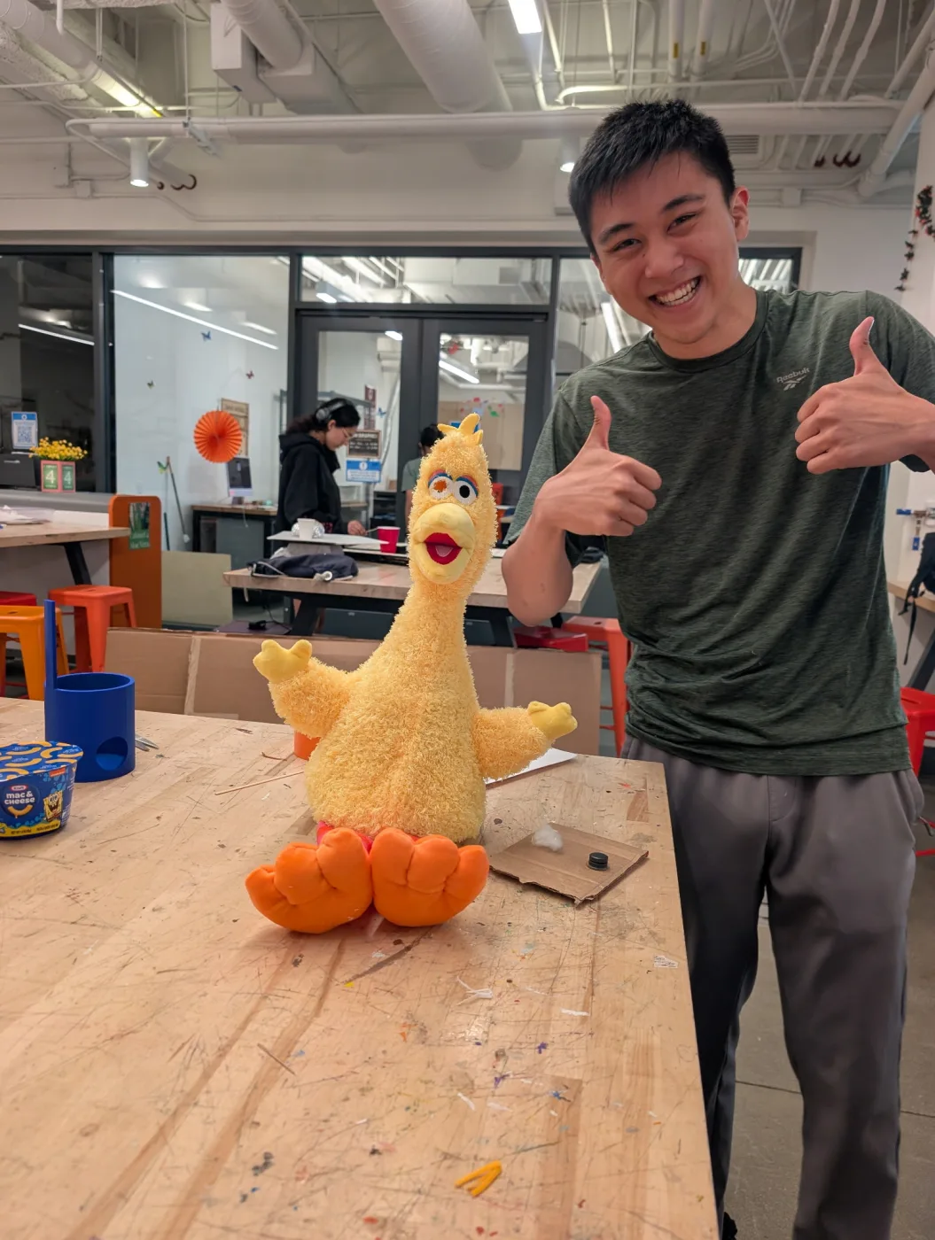 Felix in the makerspace next to the finished Big Bird puppet